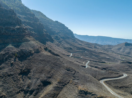 Aerial view of winding roads on the west coast of Gran Canaria, the least urbanized coast. Province of Mogan. Desert land with little vegetationの写真素材