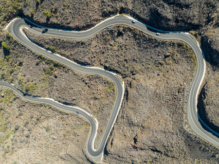 Aerial view of winding roads on the west coast of Gran Canaria, the least urbanized coast. Province of Mogan. Desert land with little vegetationの写真素材