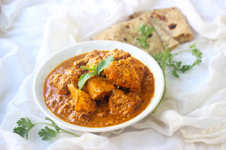 Tandoori chicken curry masala served with chapati or roti on white background.の写真素材