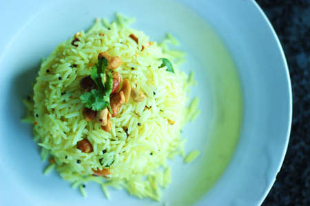 Lemon Rice.
Lemon rice is a popular south Indian dish. atop view of beautifully plated lemon rice on a white plate.の写真素材