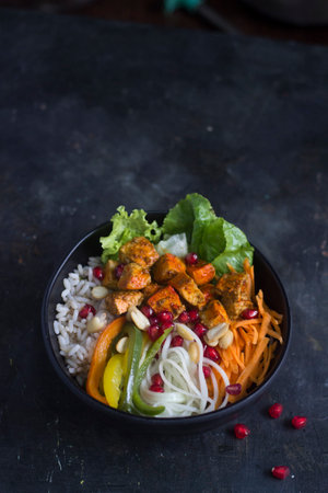 Tandoori chicken fresh salad with vegetables and fresh ingredients and yogurt mint dressing on the sideの写真素材