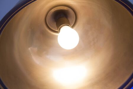 photograph of the inside of a lamp where we can see the lit bulbの写真素材