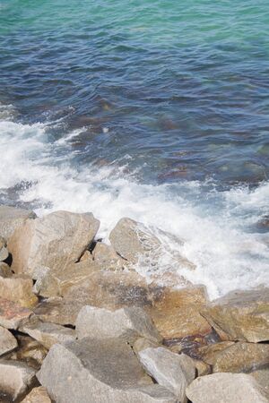 Ocean waves hitting rocks from the shoreの写真素材
