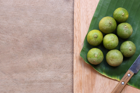 green lemon on a kitchen cutting boardの写真素材