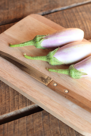 egg plant on a kitchen cutting boardの写真素材