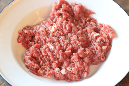Minced Meat, Fresh raw beef in dish on wood backgroundの写真素材