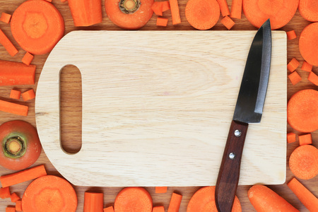carrots and empty cutting board with space for your textの写真素材