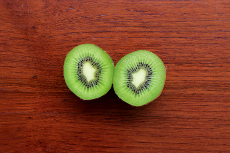 Fresh kiwi fruits on wooden table backgroundの写真素材