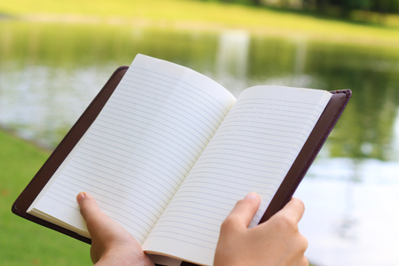 Hand holding a empty bookの写真素材