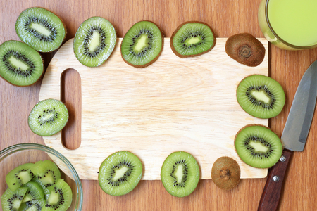 Kiwi fruit and empty cutting board with space for your textの写真素材