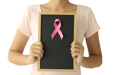 healthcare and medicine concept. Woman hand holding pink breast cancer awareness ribbon.の写真素材