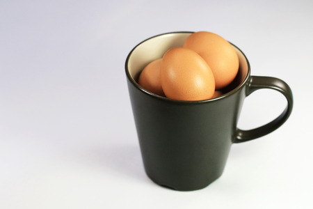 brown eggs in a Ceramic Mugの写真素材