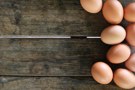 Eggs on wooden table backgroundの写真素材