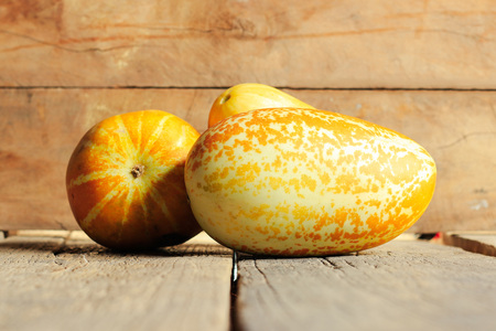 Thai melons or cantaloupe on wooden table backgroundの写真素材