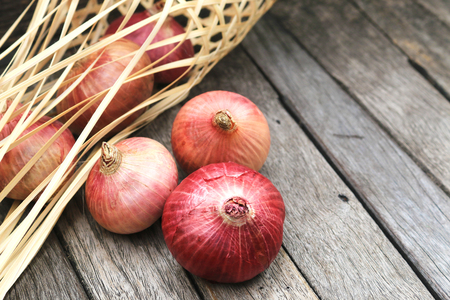 Red onion on wooden table backgroundの写真素材