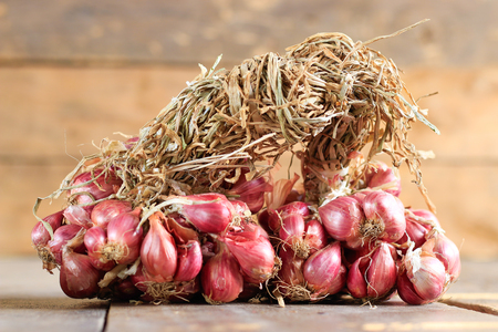 red onion on wooden table backgroundの写真素材