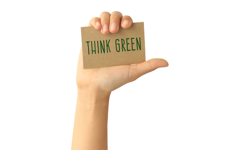 Woman hand holding think green card isolated on white backgroundの写真素材