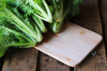 Fresh green lettuce on a kitchen cutting boardの写真素材