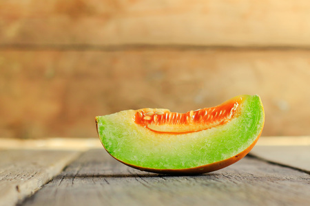 Slice of Thai melons or cantaloupe on wooden table backgroundの写真素材