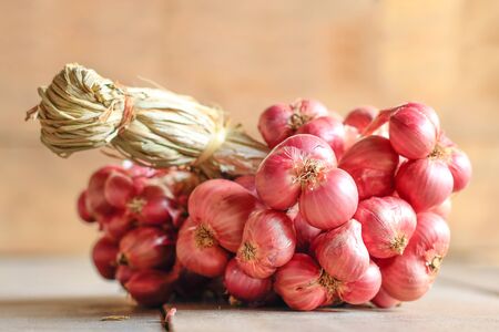 Red onion on wooden table