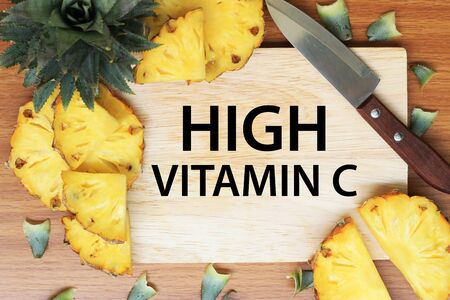 Vitamin C concept. Pineapple on a kitchen cutting board.の写真素材