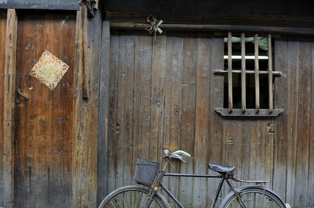 Bike against wooden house in Wuzhen,Chinaの写真素材