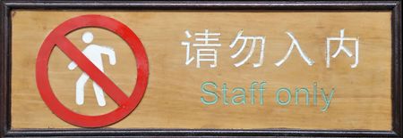 Sign on wall-- in Chinese and English in withe and green letters and characters.Entrance  Staff only の写真素材