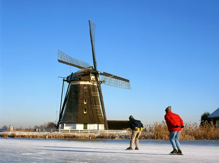Windmill and skaters at the foregroundの写真素材