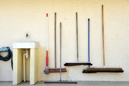 Brooms at a campingsite situated next to a sinkの写真素材