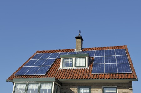 Solar Panels at red roof of old house  Copy space in clear blue sky のeditorial素材
