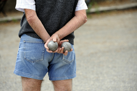 Playing jeu de boules or also called petanque in France. This play is played at street in every village of France.の写真素材