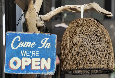 Weathered blue come in we're open signの写真素材