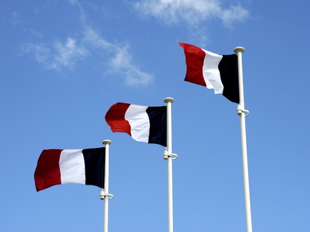 Three national flags of France with a clear blue skyの写真素材