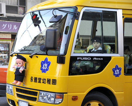 KYOTO,JAPAN-NOVEMBER 04,2014: Little pupil sitting in a yellow schoolbus from school to homeのeditorial素材