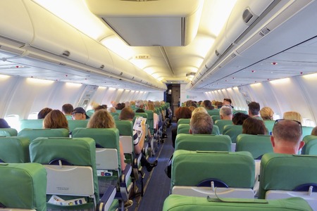 AMSTERDAM, THE NETHERLANDS - SEPTEMBER 25, 2018: People sitting inside a Transavia airplane, during...