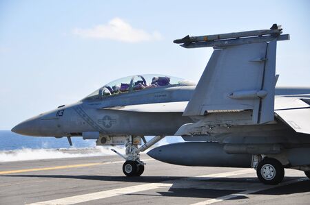 Gulf of Thailand, Thailand 5/8/2011 : An F-18 fighter jet lands on the deck of the aircraft carrier...
