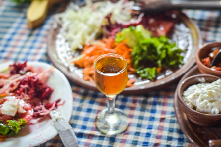Close up of a glass of beer on a plate with mixed saladの写真素材
