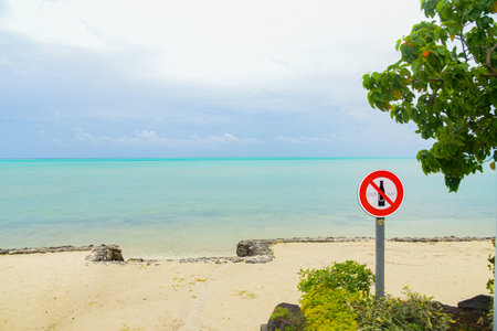 No entry sign on the beach with blue sea and sky background. Bora Bora, South Pacific island northwest of Tahiti in French Polynesiaの写真素材
