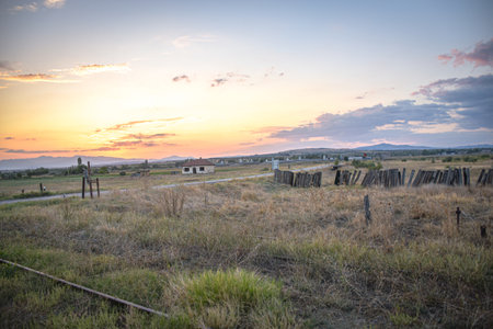Sunset in the meadow with wooden fence and village in the background, Sv. Nikole Macedoniaの写真素材