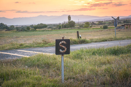 Directional sign on a rural road at sunset, Sv. Nikole Macedoniaの写真素材