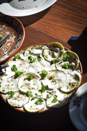 Baked zucchini with yogurt and parsley on a wooden table, Delcevo, Macedoniaの写真素材