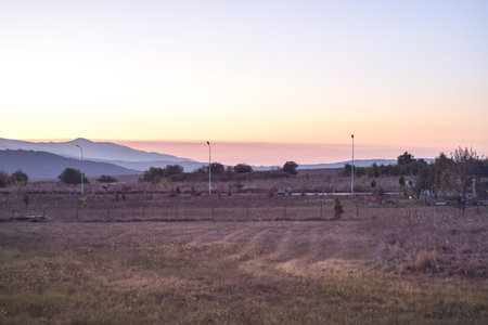 Landscape of a field at sunset with the mountains in the background, Berovo, Macedoniaの写真素材
