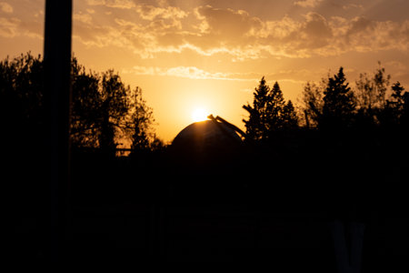 Silhouette of a house on a background of the setting sunの写真素材