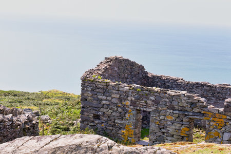 Ruins of an ancient stone house at the coast in Barmouth, Wales, UKの写真素材