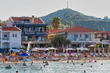 People relax on the beach in pefkochori, greeceの写真素材