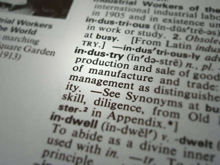 A close up of the word industry from a dictionary.  Focus and soft spots on the word industry with...