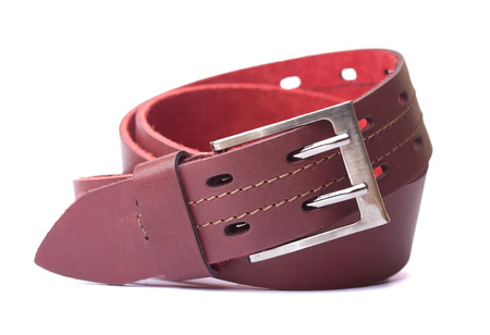 Red leather belt isolated on white backgroundの写真素材