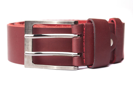 Red leather belt isolated on white backgroundの写真素材