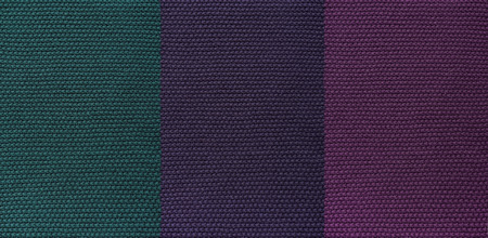 The texture of knitted woolen fabric dark. Unusual abstract background.