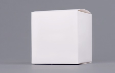 Square white carton product box mock up, side view, clipping path. Clean white cardboard blank mock up. Simple closed package template isolated. Store product pack.の写真素材